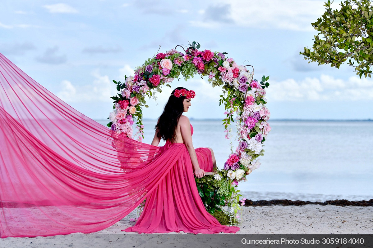 Beautiful photo of a quinceanera on the beach. Photo by Quinceanera Photo Studio 305.918.4040
