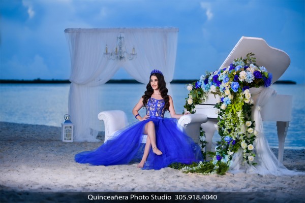 Capture the Magic of Your Quinceanera in a Short Blue Dress with a Piano on the Beach